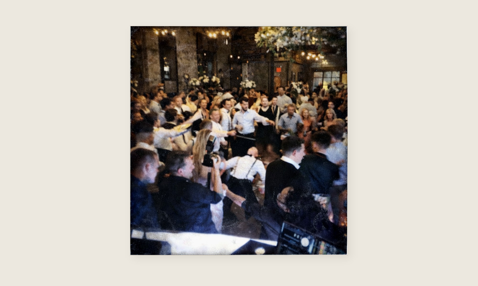 Crowded wedding dance floor during a limbo moment