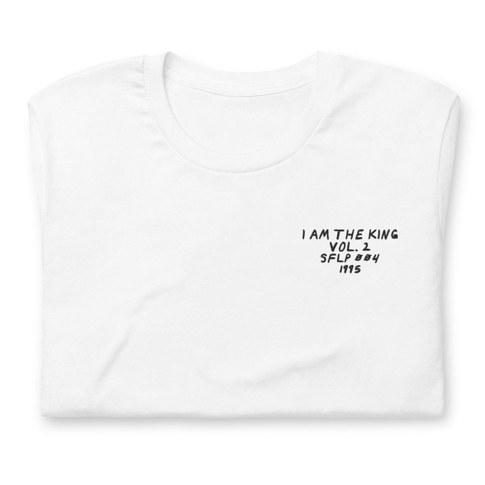 Its shirt, folded: a white tee with the record embroidered on the chest