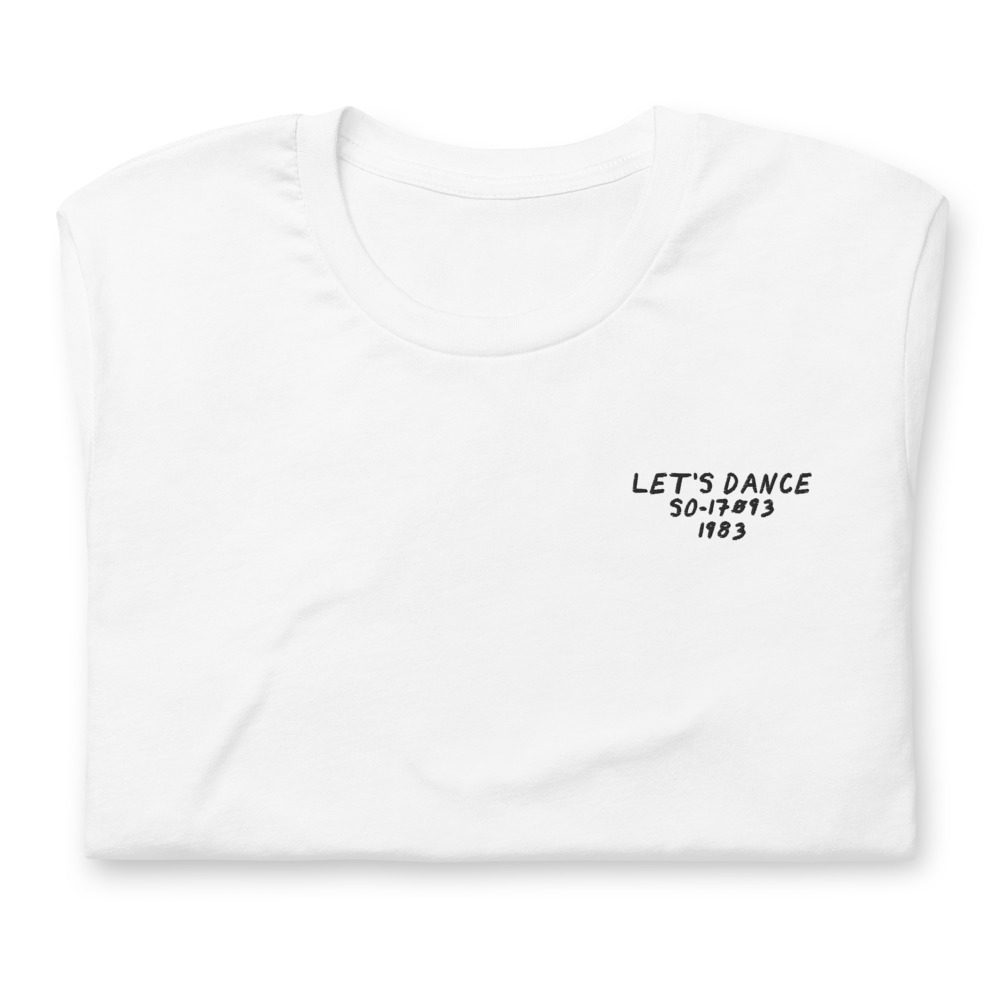 Its shirt, folded: a white tee with the record embroidered on the chest