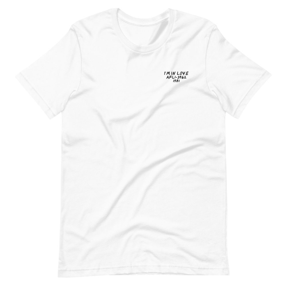 Its shirt, wrinkled: a white tee with the record embroidered on the chest