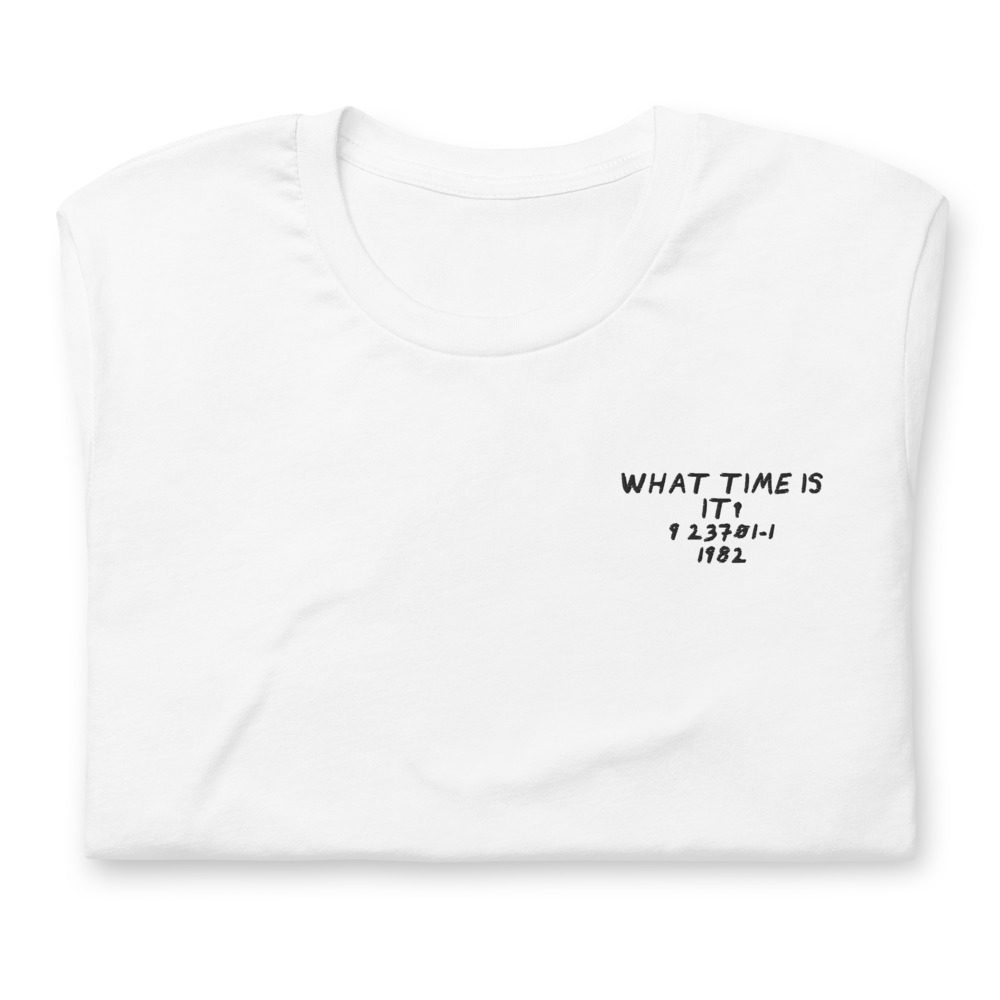 Its shirt, folded: a white tee with the record embroidered on the chest