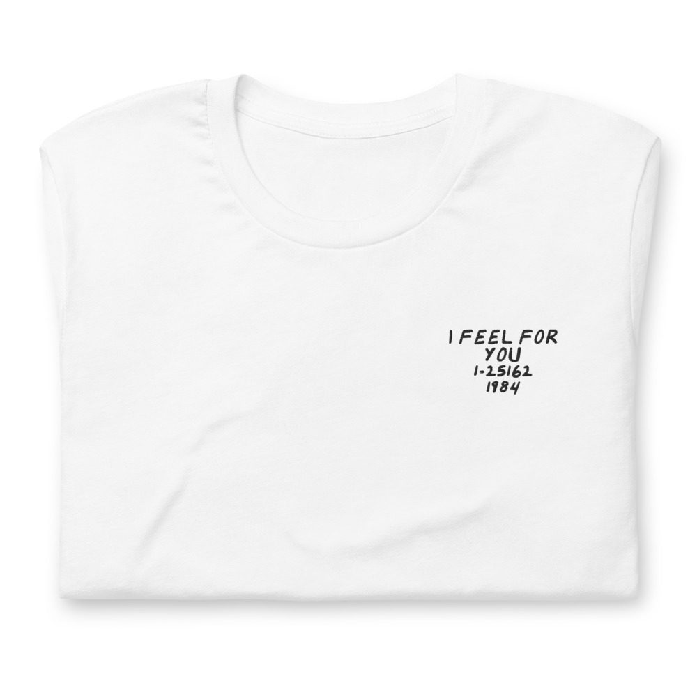 Its shirt, folded: a white tee with the record embroidered on the chest