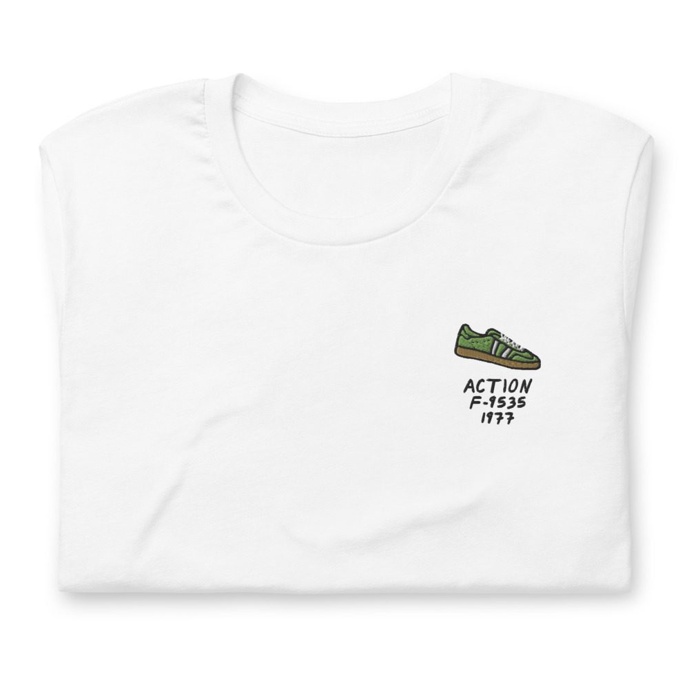 Its shirt, folded: a white tee with the record embroidered on the chest