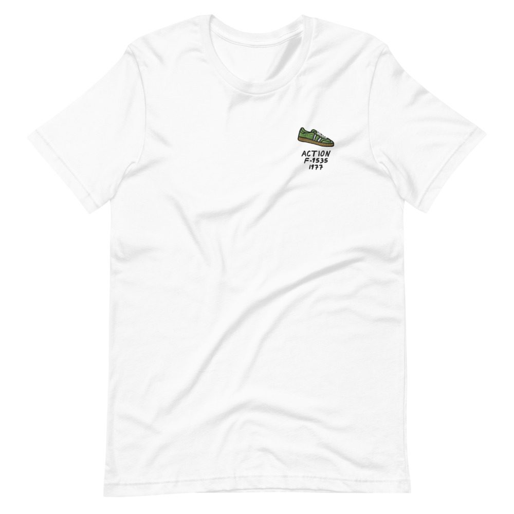 Its shirt, wrinkled: a white tee with the record embroidered on the chest