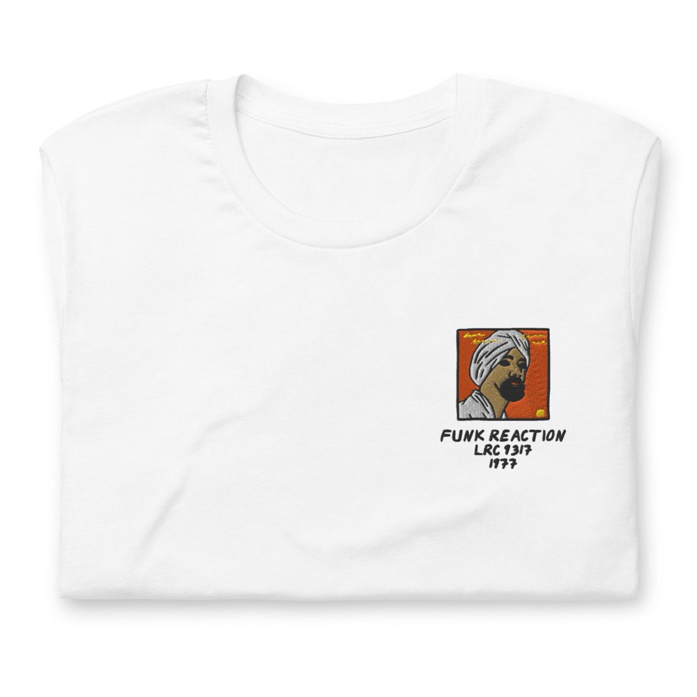 Its shirt, folded: a white tee with the record embroidered on the chest