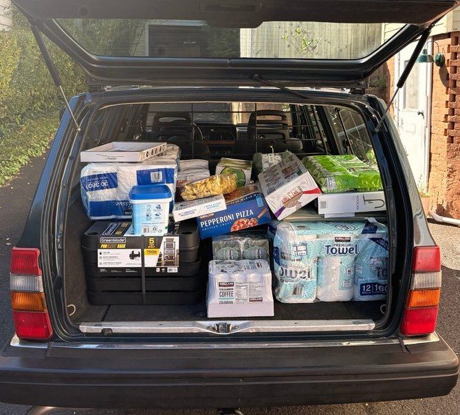 Her tailgate up, the back packed full from a Costco run.
